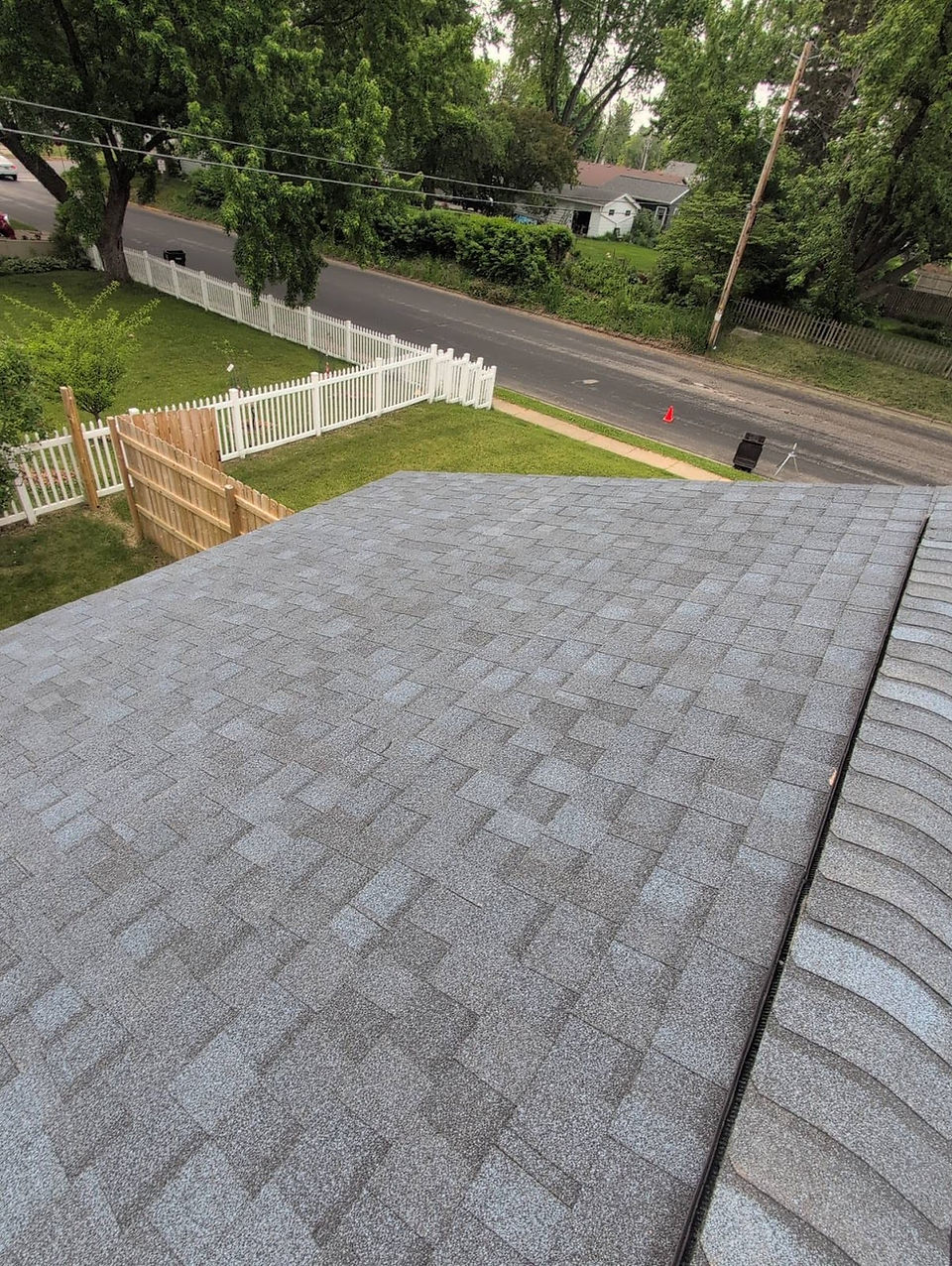 new grey shingles on roof looking down from ridge