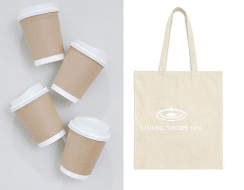 Four brown paper cups with white lids on the left; beige tote bag with "Living Shore Spa" logo on the right, on a light background.