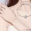 Thumbnail: simple silver bracelet, with a small sturdy silver heart in the middle, on a ladies wrist