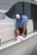 Close-up view of a boat hull being cleaned and polished