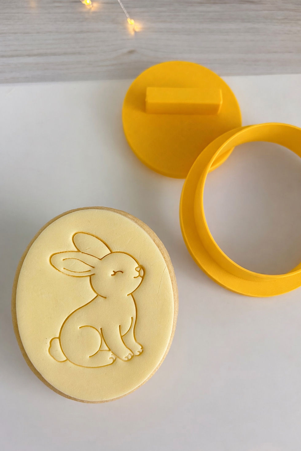 Thumbnail: Oval pastel lemon fondant police with cute Easter bunny outline drawing stamped