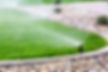 Automatic sprinklers watering grass.jpg