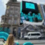 Woman views large Coffee machine placed inside buidling
