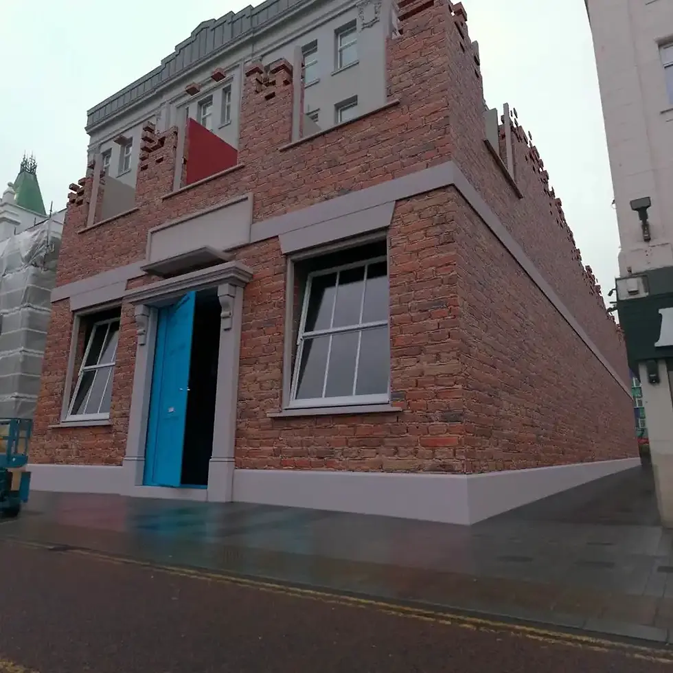Red brick buidling covering white facade