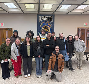 Diverse group of people under a Teamsters banner.