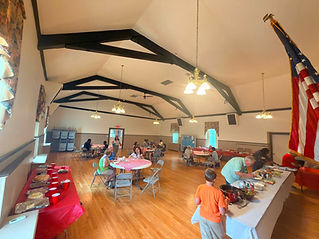 Wide angle of the church hall filled with people for a community gathering