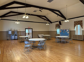 Alternate angle of tables and chairs displayed in the empty hall
