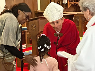 The Bishop blessing a young parishioner in the church