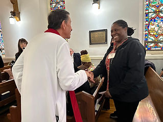 The Bishop speaking with a church member who displays a wide smile