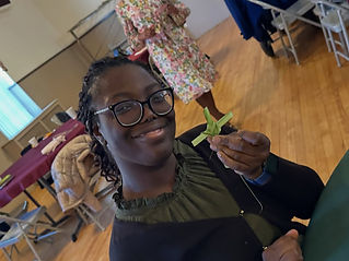 Young church member holding a cross made from palm leaves