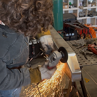 Hand grinding weld seams on a custom steel Jeep Cherokee XJ bumper — 633 Fabrication Loomis CA