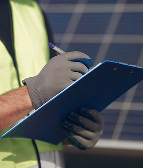 man-with-white-helmet-near-solar-panel.jpg