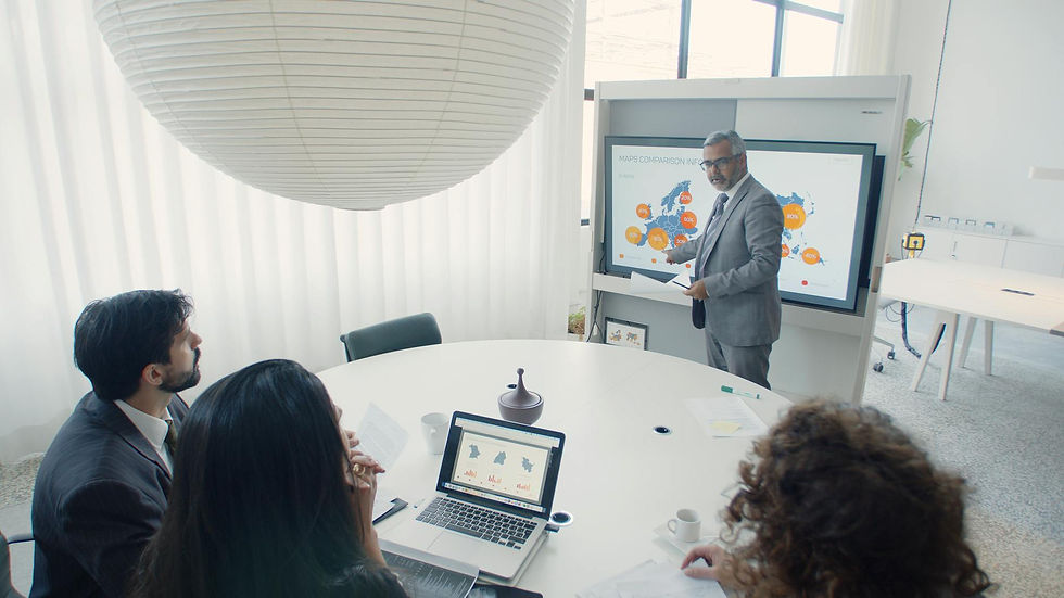 Professional team engaged in a business presentation in a modern office setting.