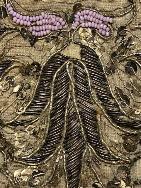 fine linen backing can be seen tulip decoration in metal thread and murano glass beads and sequins embelish the decoration