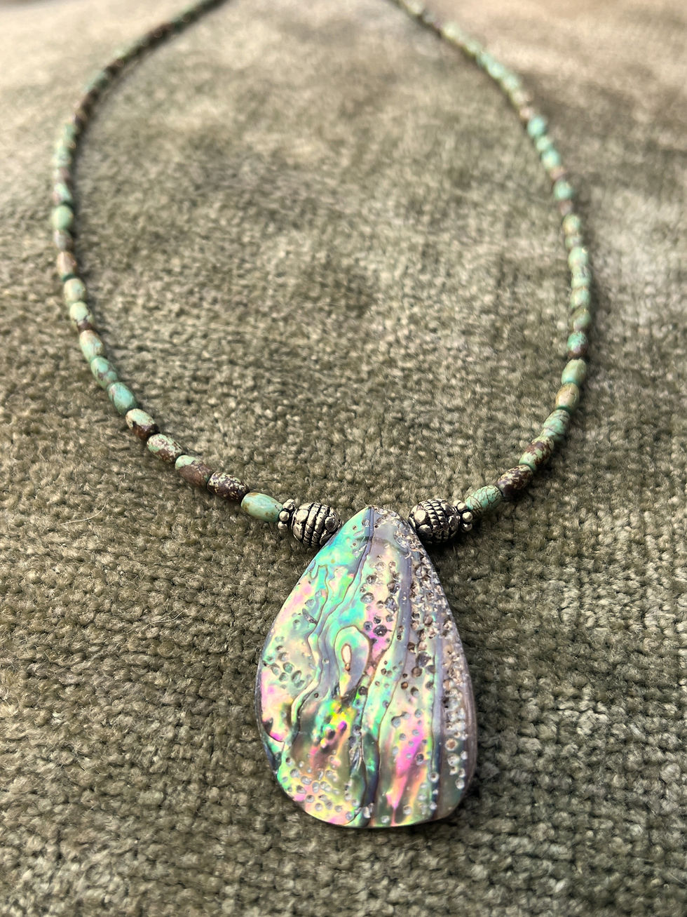 turquoise stone necklace beaded with tiny sage green rice-sized beads and an abalone shell pendant