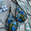 Thumbnail: long copper teardrop earrings wire wrapped with a flower garden of sky and aqua blue glass beads
