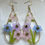 Thumbnail: lavender pink and periwinkle blue flower earrings beaded with a pink butterfly glass bead
