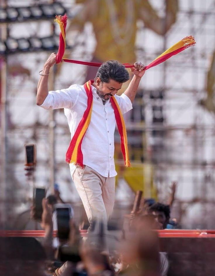 Actor Vijay, TVK Head, in white shirt and red scarf