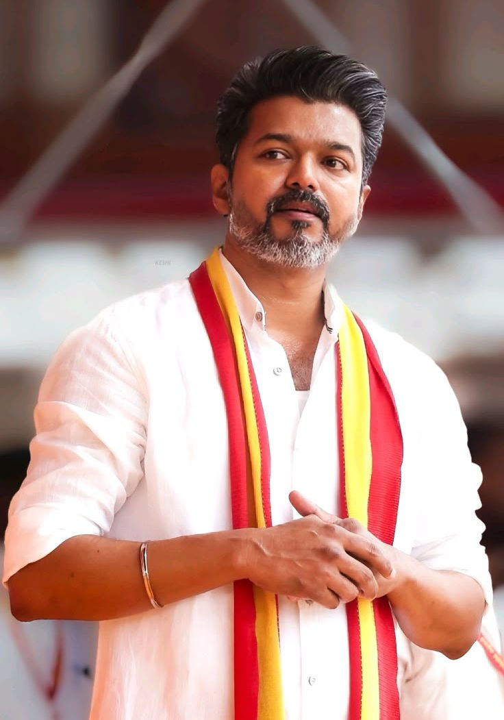 Actor Vijay, TVK Head, in white shirt and red scarf