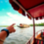 friend hand on shoulder and other hand pointing towards the houseboat kerala.jpg