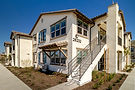 Modern apartment building with external stairs.