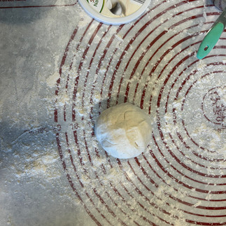Turn the dough ball out onto a lightly floured surface