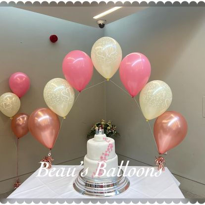 Balloon arch above a cake