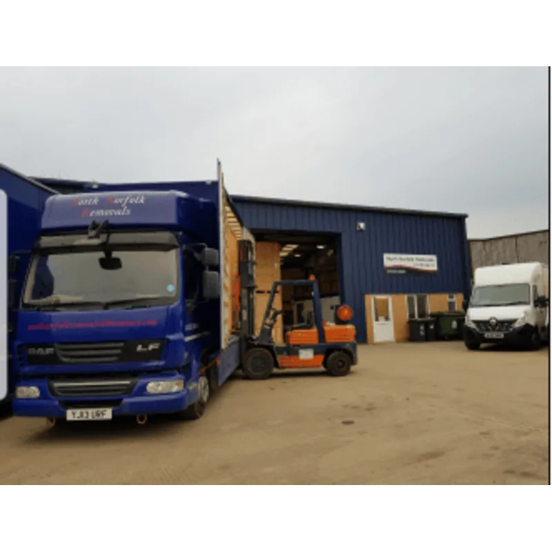 removing a large crate from a van into a warehouse