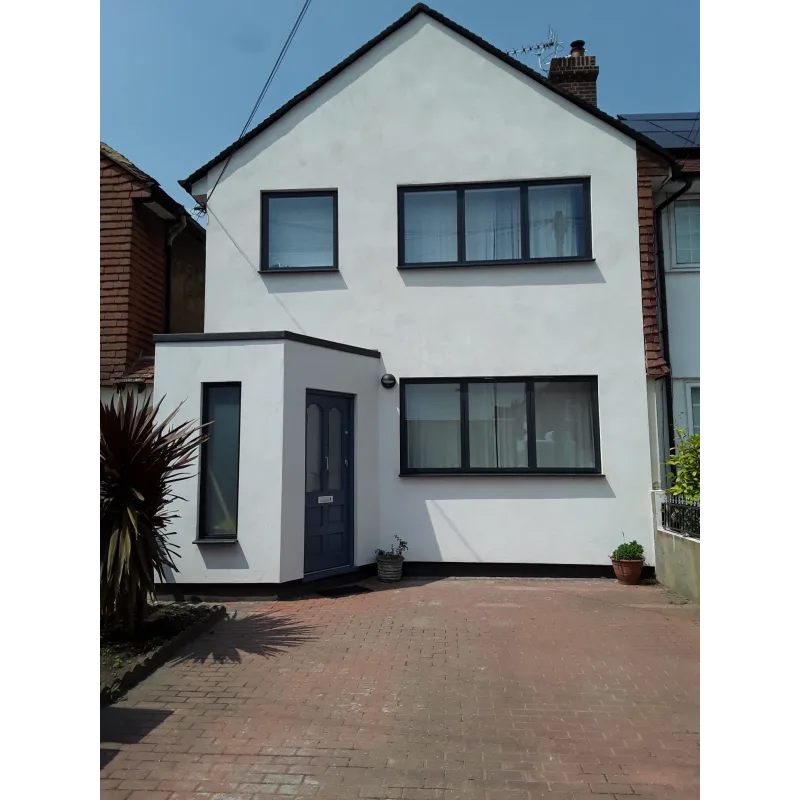 Large white house with a brick driveway