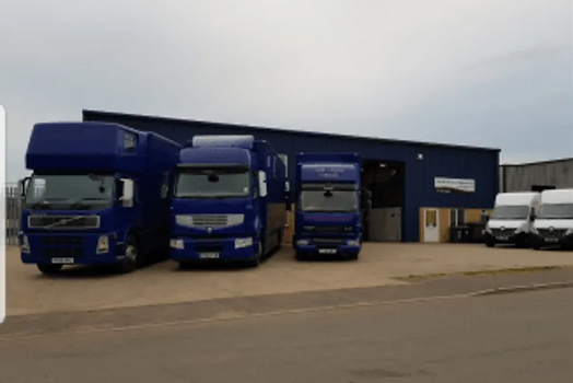 blue vans parked in a row outside of a w