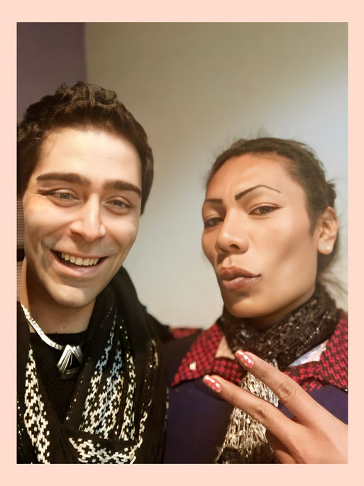Paola and PJ DiPietro smiling while taking a selfie indoors, both dressed stylishly.