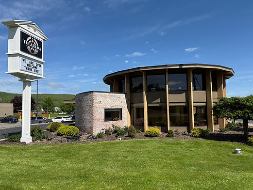 exterior photo of The Arena with brand new logo and "open" sign