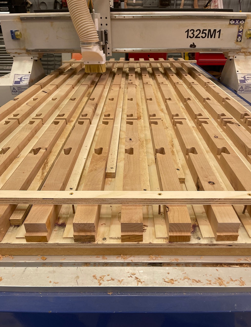 Custom Chisum barstool legs being carved and cut for assembly