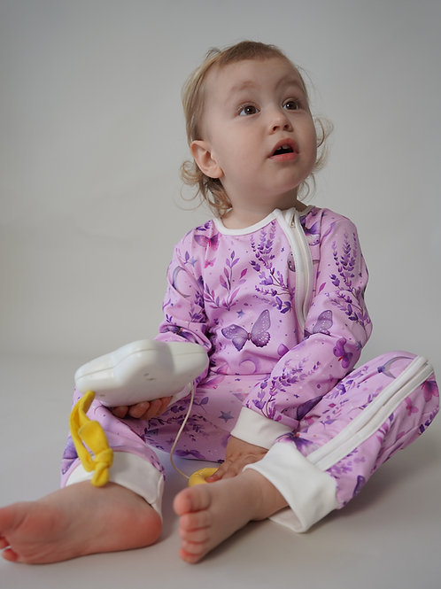 Baby sitting and playing while wearing pink butterfly baby romper