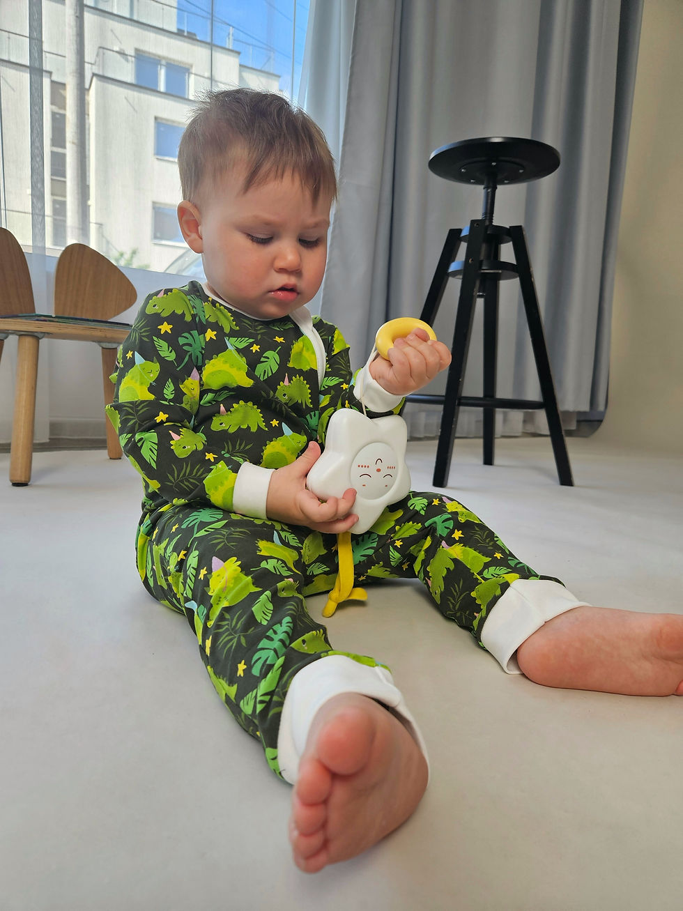 Thumbnail: Baby sitting and playing wearing Green dino baby romper with zipper