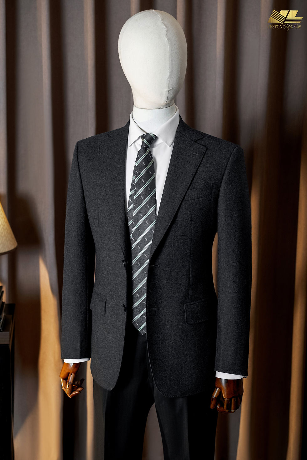 Elegant grey tailored suit, classic notch lapel design, yet youthful