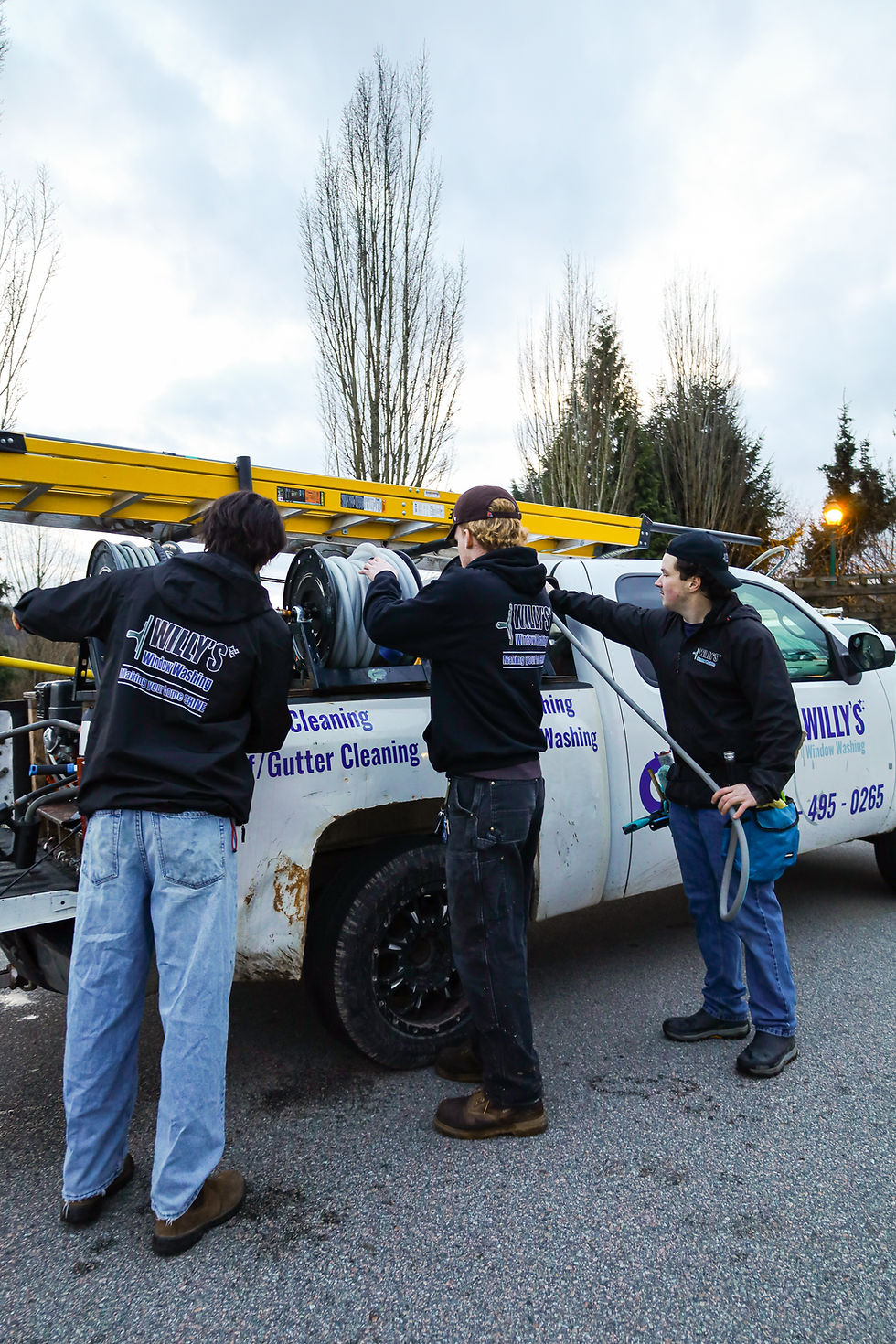Willy's Window Washing crew getting equipment ready beside their work truck