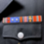 Medal ribbon bar of SS-Obergruppenführer John Smith from "The Man in the High Castle" mounted over left pocket. For sale.