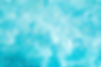 blurred-transparent-blue-colored-clear-calm-water-surface-texture-with-splashes-and-bubble