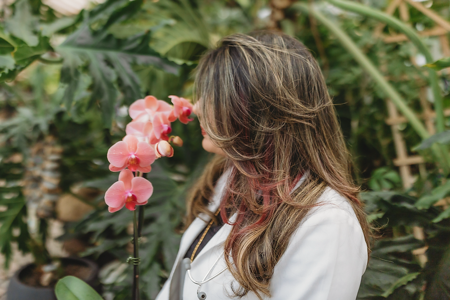 Dr Ban smelling orchids