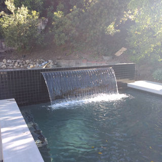 Custom luxury Backyard Environments Pool water fountain in Montecito