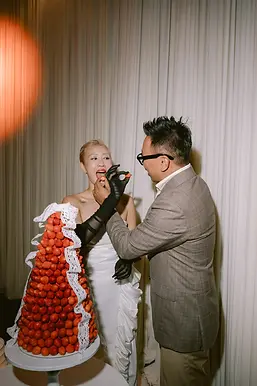 Cặp đôi cùng thưởng thức bánh cưới phủ dâu tây trong khoảnh khắc vui vẻ và gần g ũi.