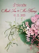 Floral decoration with pink orchids and greenery for a Vietnamese tea ceremony backdrop.