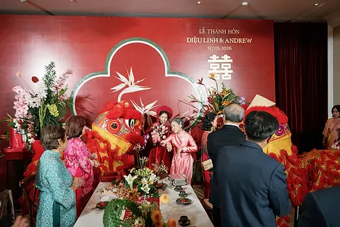 Lion dancers and family gathered around the ceremony table as the bride receives blessings from her elders