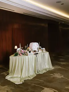 Gallery table decorated with flowers, framed photos, candles, and personal wedding details.