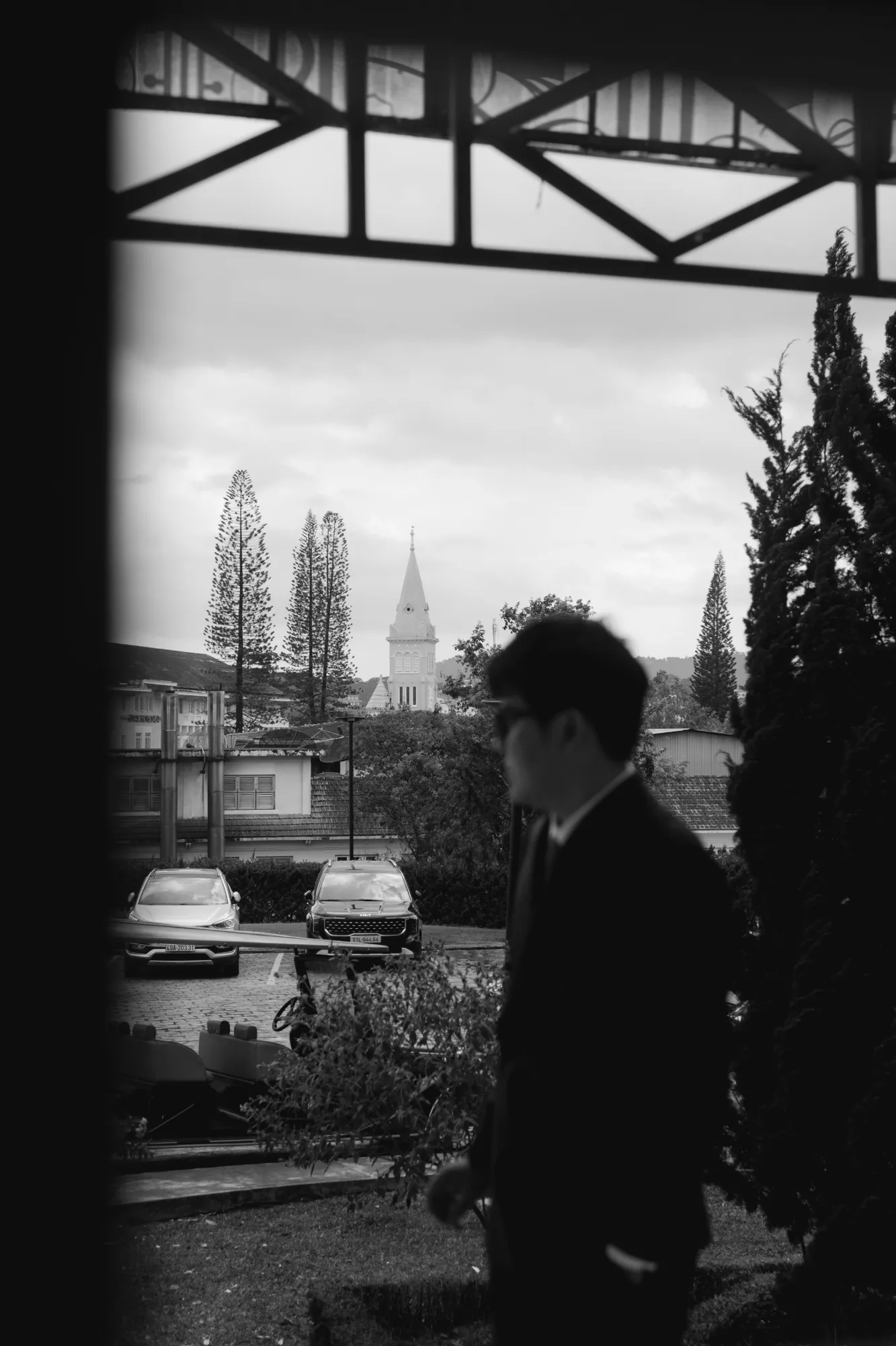 Groom looking outside before the wedding ceremony in Da Lat reflecting about the day.