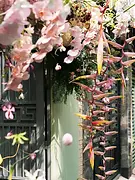Tropical flowers and orchids decorating the entrance for a Vietnamese tea ceremony at home.