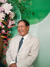 A wedding guest smiling and laughing during the tea ceremony celebration.