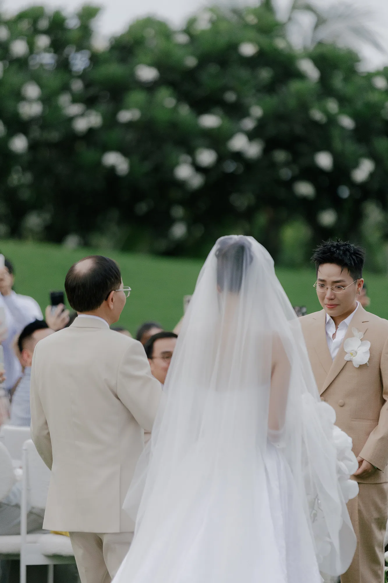 A father walks his daughter down the aisle, being by her side in her special moment.