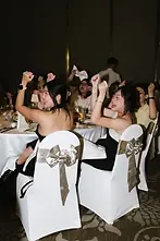 Enthusiastic guests cheering and celebrating at ballroom wedding in Saigon